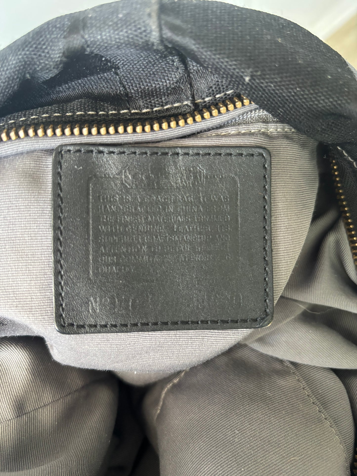 Black large coach Carly